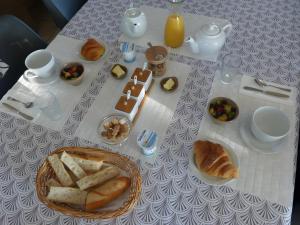 a table with bread and a plate of food on it at Entre Brionnais Et Bourbonnais in Montaigüet-en-Forez +19 photos