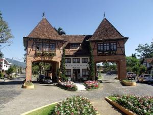 a large building with an archway in a street at Large apartment in the center in Pomerode