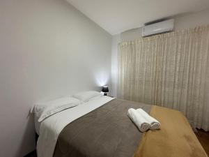 a bedroom with a bed and a window with a heater at Large apartment in the center in Pomerode