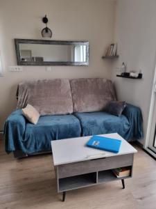 a living room with a couch and a table at TY Nid in Lannion
