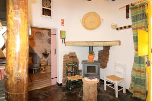 a living room with a wood stove in a room at Casinha das Portas Amarelas in Monsaraz