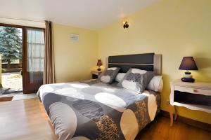 a bedroom with a large bed and a window at Chambres D'hôtes Le Sahut in Castelnau-Pégayrols +13 photos