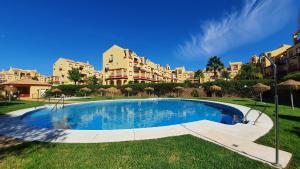 a large swimming pool in front of a large building at Sun And Moon in Ayamonte