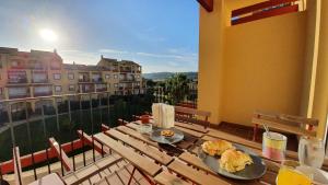 a table with two plates of food on top of a balcony at Sun And Moon in Ayamonte