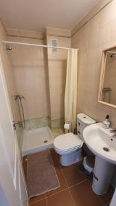 a bathroom with a toilet and a sink and a shower at Sun And Moon in Ayamonte +21 photos