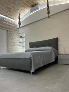 a bedroom with a large bed in a room at Twins Luxury Suite - Barletta in Barletta