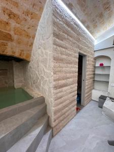 a room with a stone wall and stairs at Twins Luxury Suite - Barletta in Barletta +33 photos