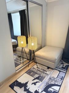 a bedroom with a bed and a mirror at Rautatien ullakkohuoneisto in Karkkila