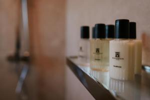 a group of four bottles of moisturizers on a shelf at Black Beach Suites in Vík +38 photos
