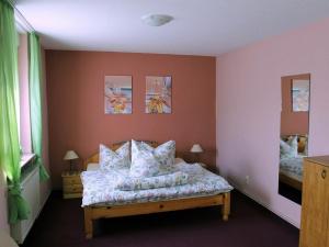 a bedroom with a bed with pillows on it at Hotel & Gasthaus Forelle in Thale