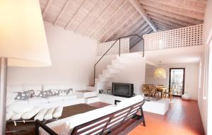 a living room with white furniture and a staircase at Quinta Do Miguel in Aldeia do Meco