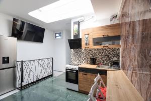 a kitchen with a sink and a stove top oven at AISHA Hostel in Ljubljana