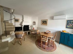a kitchen and dining room with a table and chairs at Authentic village house in Goult