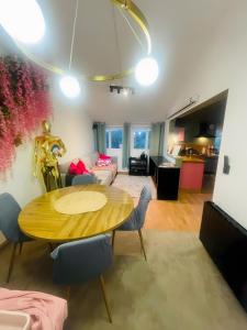 a dining room and living room with a table and chairs at Maison Donarosa Charmant in Vieille-Brioude