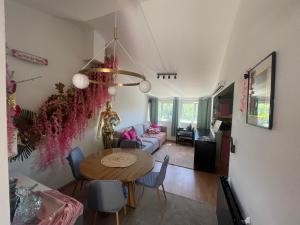 a living room with a table and a couch at Maison Donarosa Charmant in Vieille-Brioude