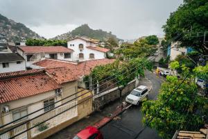 a car parked on a street next to buildings at APTO - Espaço Vix II in Vitória