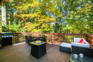 a deck with a couch and a fire pit at Front-Row Smoky Mountain Views - Mountain View, Fire Pit, Grill in Sevierville