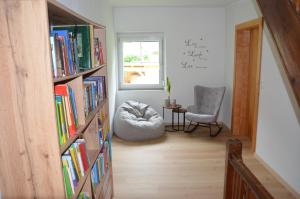 a room with a book shelf filled with books at Gästehaus Manuela in Lind