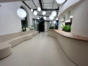 a hallway in a building with white floors and lights at Moov Hotel São Paulo in São Paulo