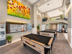 a billiard room with several pool tables in it at Aparthotel SunClub Salou in Salou