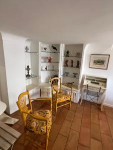 a living room with chairs and a table and a piano at Authentic village house in Goult