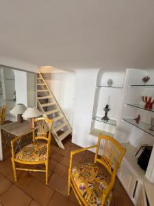 a room with two chairs and a table and shelves at Authentic village house in Goult +9 photos