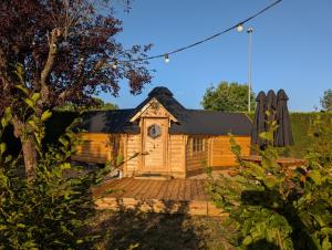 a log cabin with a deck in a yard at Camping de Graçay in Graçay +31 photos
