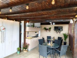 a kitchen and dining room with a table and chairs at Vila Natalia in Vama Veche