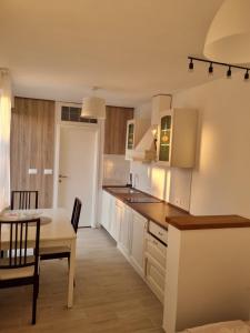 a kitchen with a table and a dining room at Apartma DUA in Strunjan