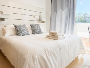 a white bed with towels on it in a room at Condado de Alhama 5 SV29 in Alhama de Murcia