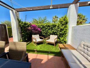 a patio with two chairs and a table at Condado de Alhama 5 SV29 in Alhama de Murcia