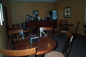 a restaurant with tables and chairs and a bar at Americas Best Value Inn Big Lake Becker in Big Lake