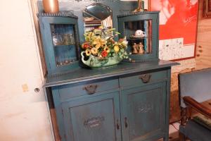 a blue cabinet with a vase of flowers on it at Exceptional B&B in Reeuwijk +40 photos