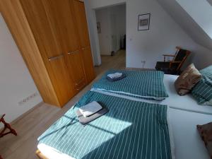 a bedroom with two beds with green sheets at Alte Mühle in Holzminden