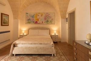 a bedroom with a bed and two night stands at Residenza Kalù in Grottaglie +60 photos