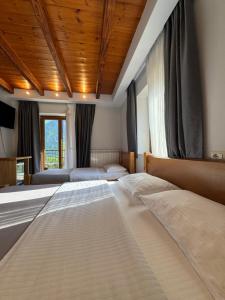 a large bedroom with two beds in it at Gegest Hotel in Theth +37 photos