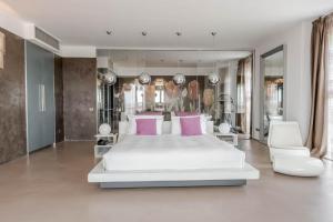 a bedroom with a large white bed and pink pillows at Hotel For You in Cernusco sul Naviglio