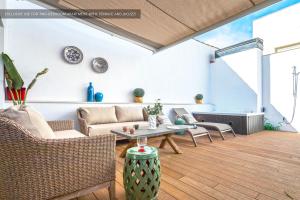 a living room with a couch and a table at Genteel Home Castilla Terrace in Seville