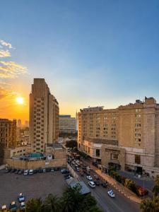 a city with cars parked in a parking lot at Landmark Hostel Cairo in Cairo