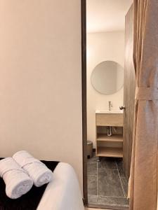 a bathroom with a bed and a sink and a mirror at Zentio Hotel in Bogotá +7 photos