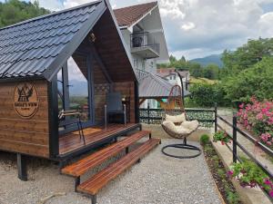 a tiny house with a bench and a chair at Eagle's View Cabin in Plav