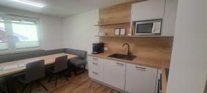 a small kitchen with a table and a microwave at Haus Bergfried in Filzmoos +60 photos