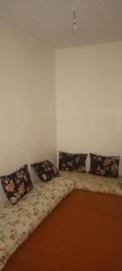 a room with a couch with four pillows on it at colomina SIDI IFNI in Sidi Ifni