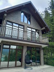 a house with a balcony and a deck at Tara Organic in Zaovine