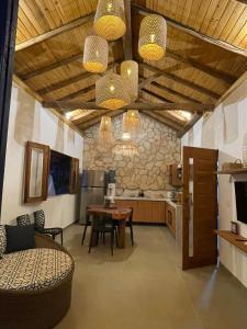 a living room with a couch and a table at Sumar your beach house in Japaratinga in Japaratinga