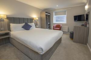 a hotel room with a large bed and a television at Parkmore Hotel & Leisure Club, Sure Hotel Collection by BW in Stockton-on-Tees +50 photos