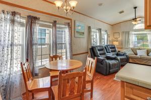a living room with a table and a couch at Pool + Dock Access! Boater’s Base in Lake Placid in Lake Placid