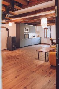 a living room with a table and a kitchen at Kuća za odmor Čevo in Podevčevo +28 photos