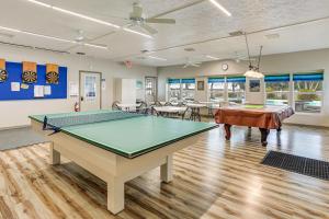 a room with a ping pong table in it at Pool + Dock Access! Boater’s Base in Lake Placid in Lake Placid