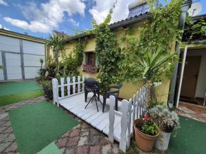 a house with a white fence and a table and chairs at Penzion Many Peny in Jindřichŭv Hradec
